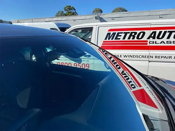 A stone chip that has spread into a long crack across a windscreen